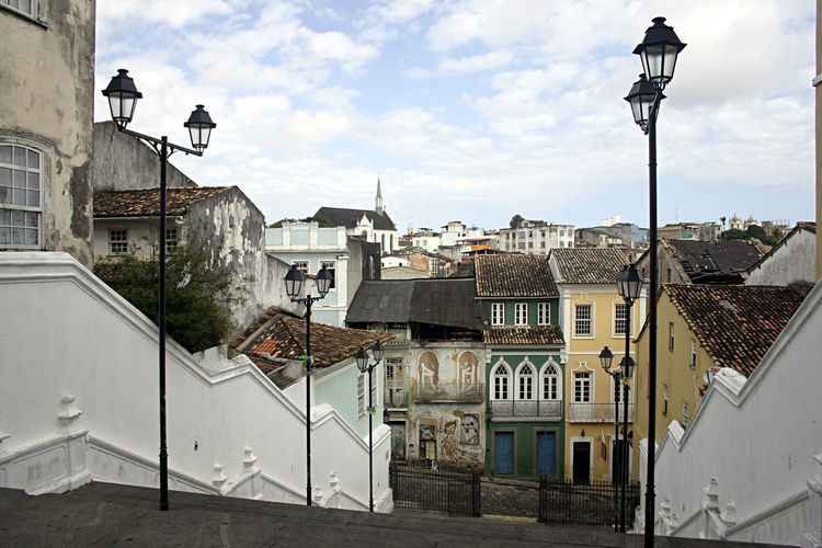 Buildings in town against cloudy sky