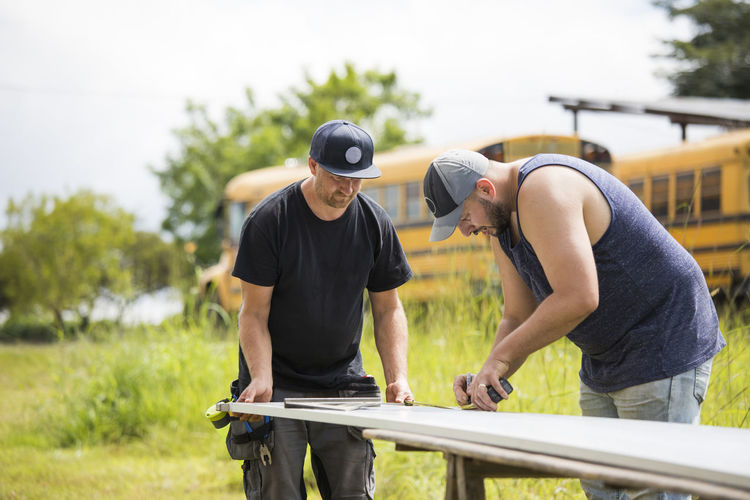 Two men working to assemble solar panels.