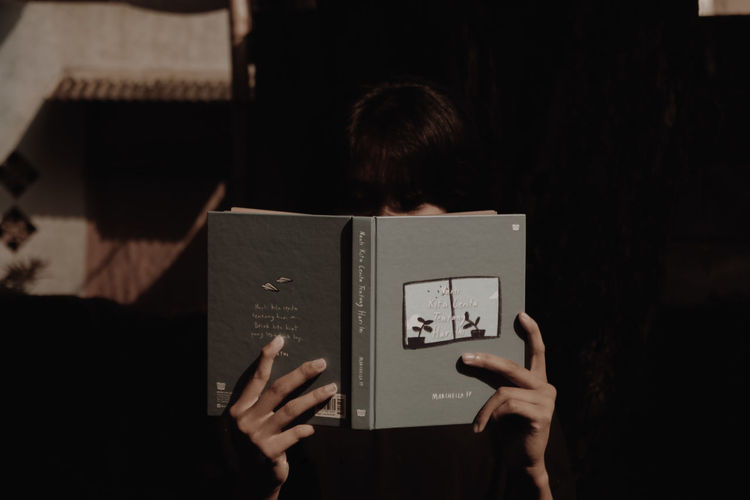 Rear view of woman reading book