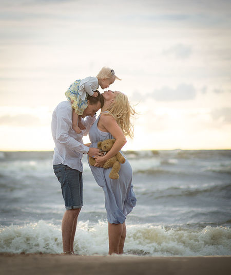Parents with baby girl at beach