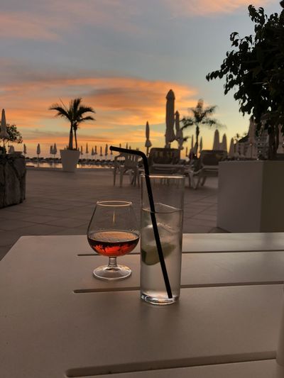 View of drink on table at sunset