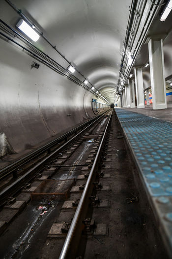 Empty urban subway train platform tunnel and tracks