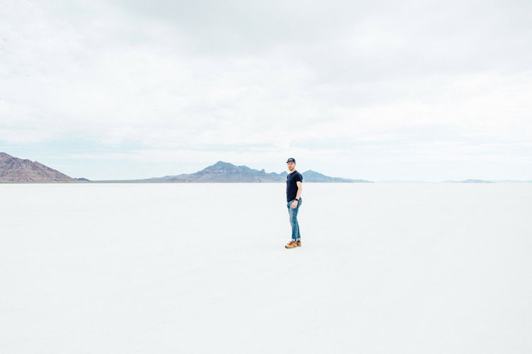 Full length of man standing on shore against sky