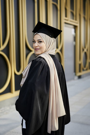 Smiling woman wearing graduation hat