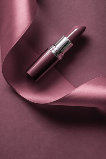 High angle view of lipstick with ribbon on table