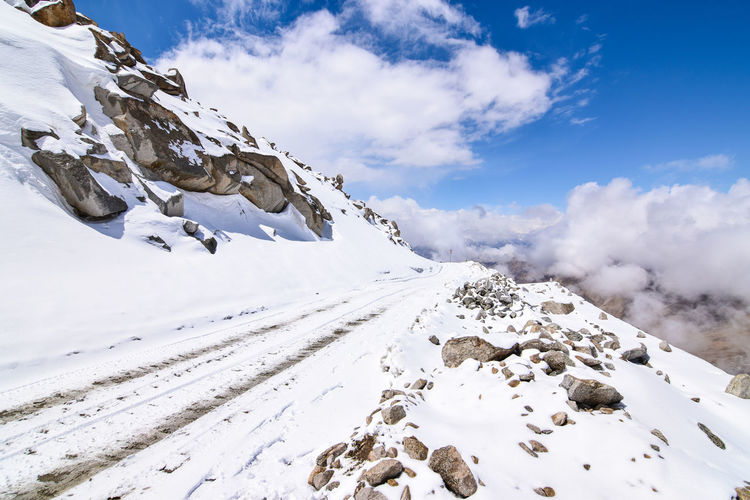 Low angle view of snowcapped mountain against sky