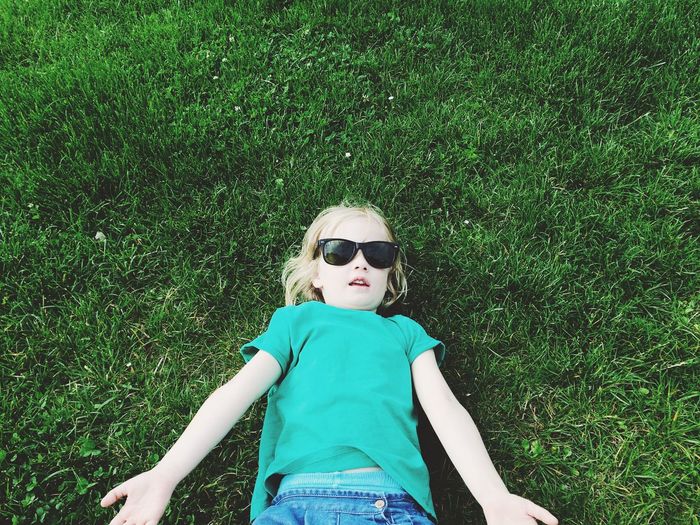 High angle portrait of girl on sunglasses on field