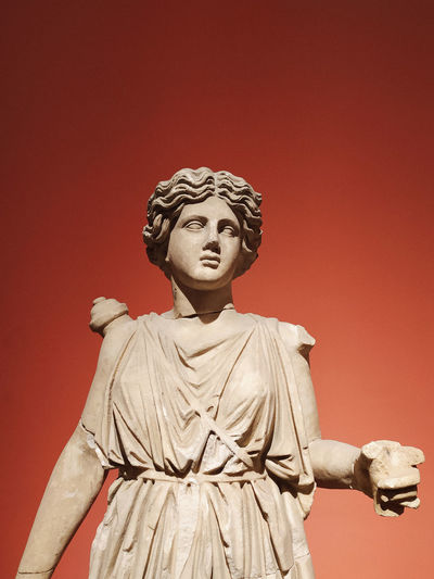 Close-up of statue against red background