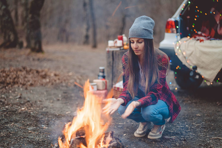 Woman sitting on bonfire