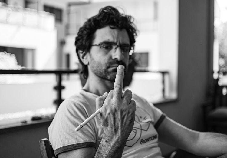 Portrait of a man making the middle finger gesture