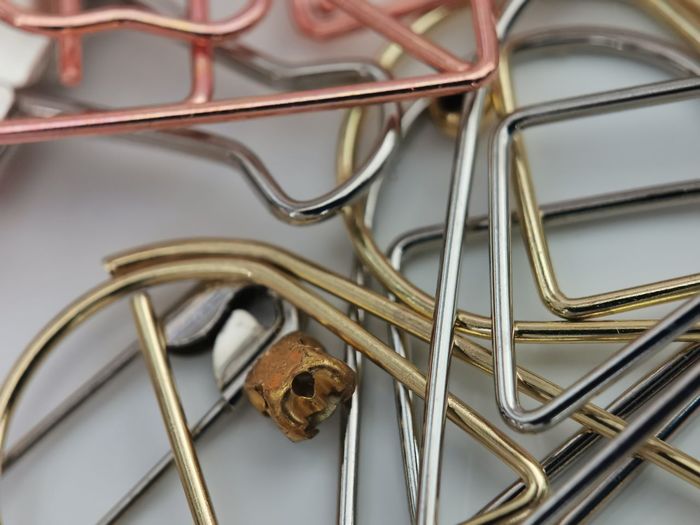 Close up of various paperclips on table