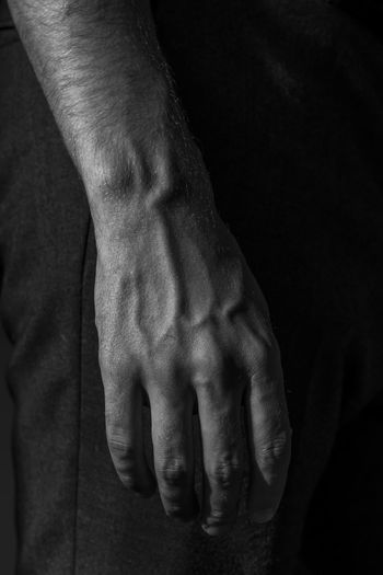 Cropped hand of man in darkroom