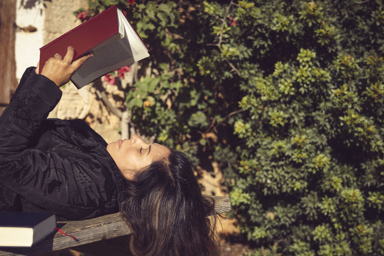 Young woman reading book