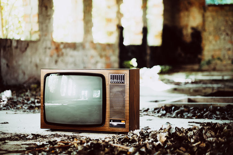 Old television set in abandoned house