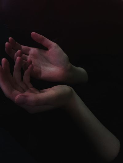Close-up of hands over black background