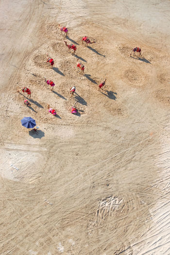 High angle view of multi colored umbrellas on sand