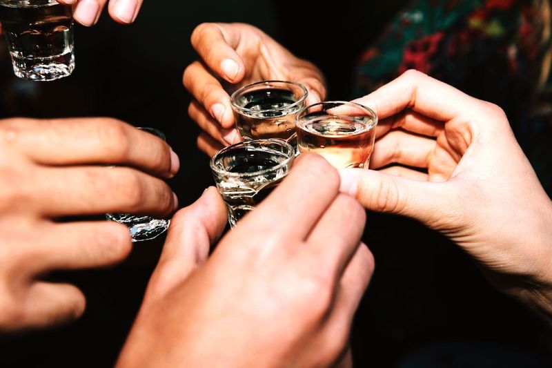 Cropped hands of friendship toasting drinks