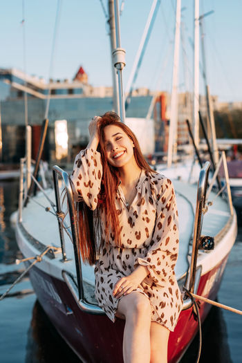 Portrait of smiling young woman in boat