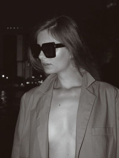 Portrait of woman wearing sunglasses standing outdoors