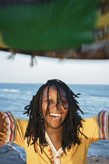 Portrait of cheerful young woman at sea