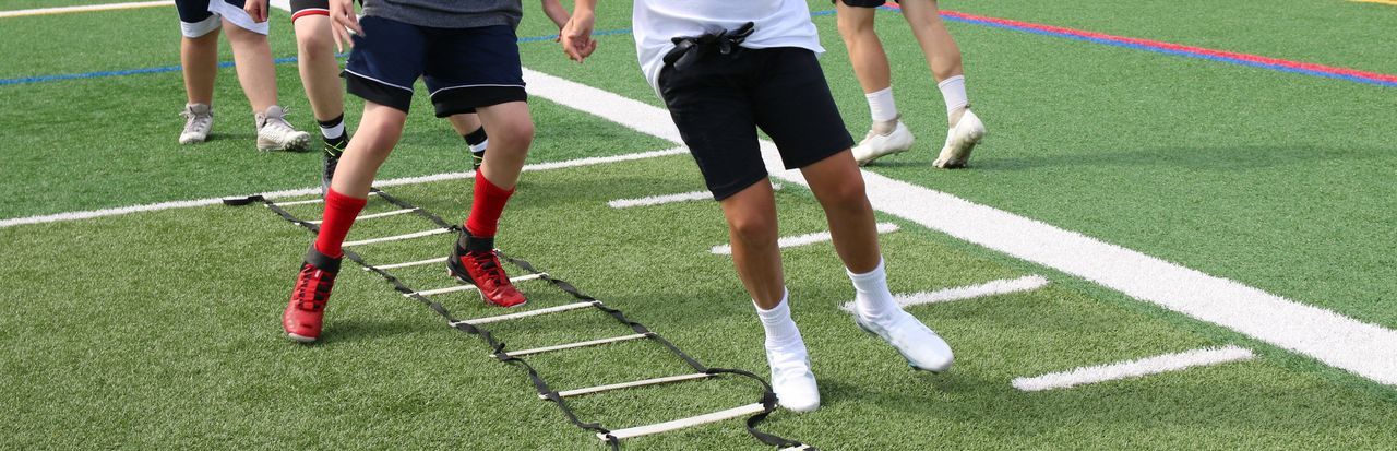 Low section of people walking on field