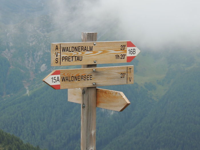 Wooden information signs against mountain