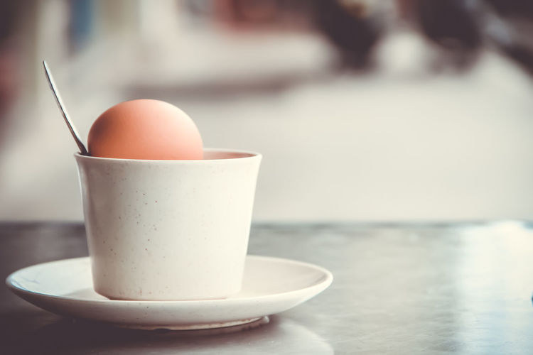 Close-up of eggs in cup on table