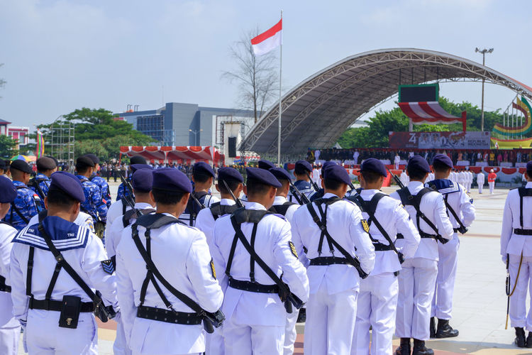 Men in uniforms standing outdoors during parade