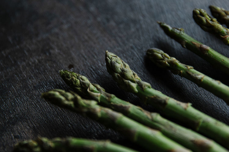 Bunch of green asparagus on wooden surface
