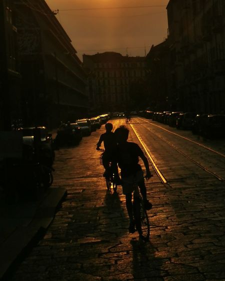 People walking on street in city at dusk