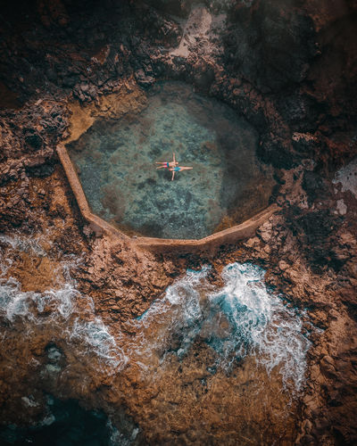 Aerial view of water flowing through rocks