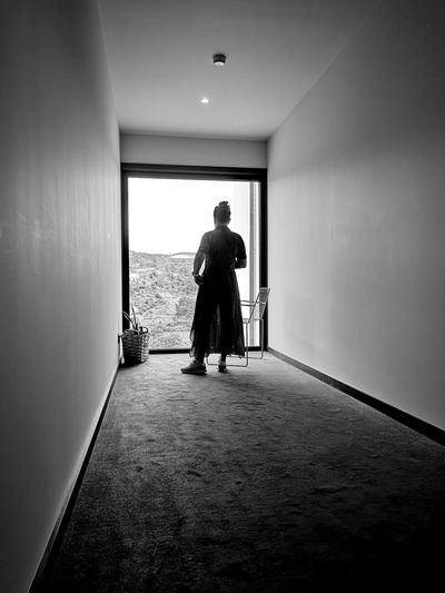 Rear view of man walking in building