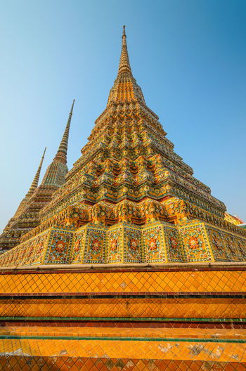 Low angle view of wat pho against clear sky