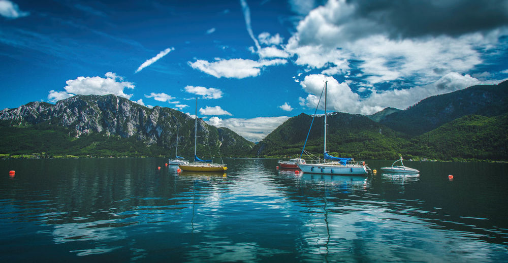 Boats on lake against sky