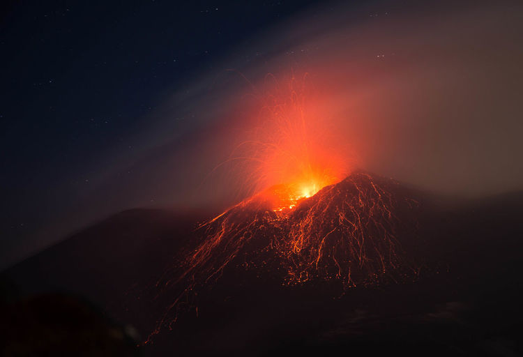 Etna volcano eruption with lava explosion in the night - sicily 