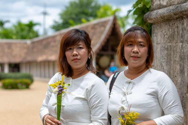 Portrait of women holding flowers