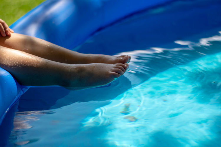 Low section of child in wading pool