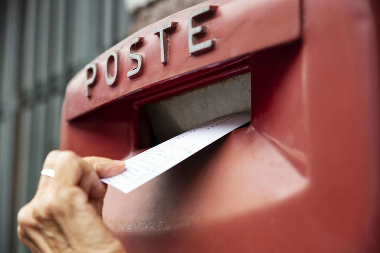 Woman dropping envelope in postbox
