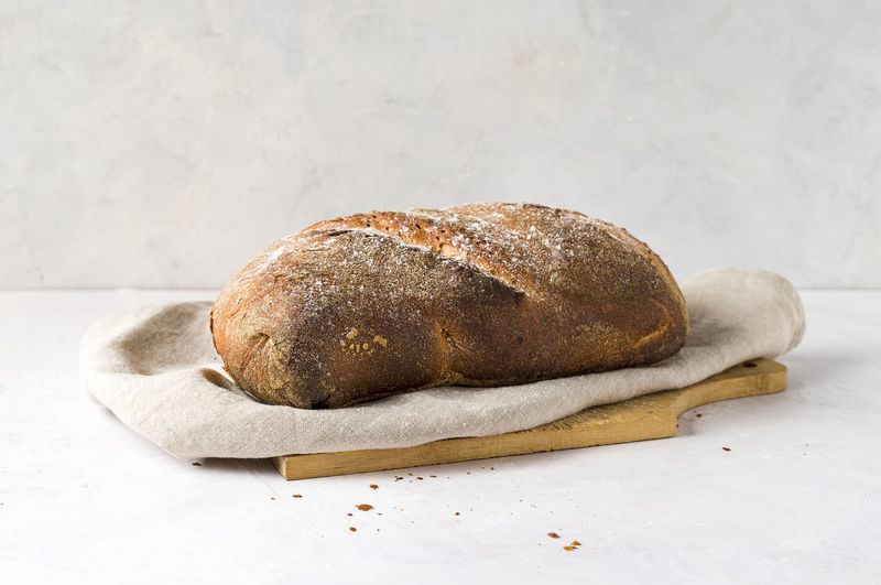 Close-up of bread on table against white background
