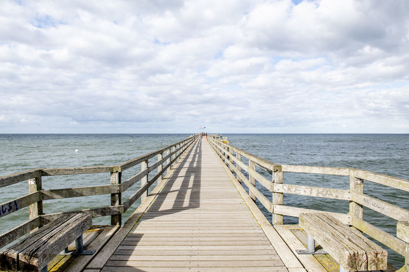 Pier over sea against sky