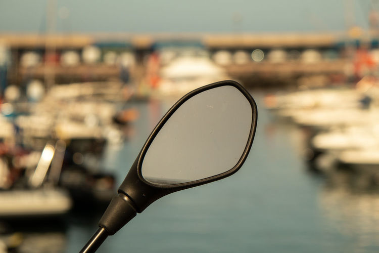 Close-up of eyeglasses on table by sea