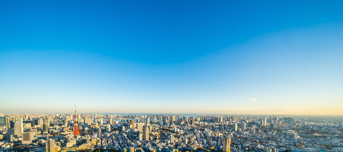 Aerial view of cityscape against clear sky during sunset