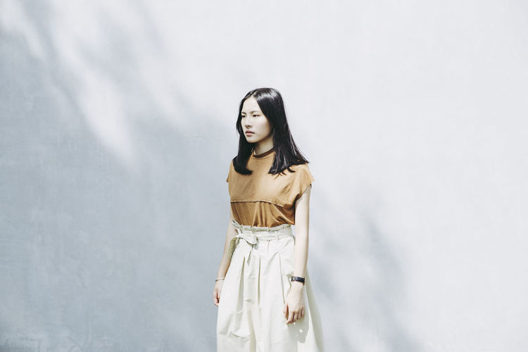Woman standing against wall