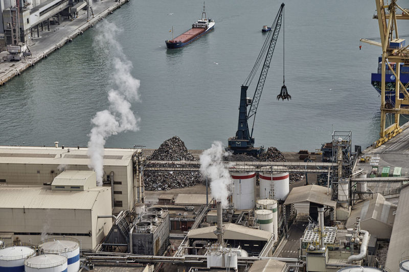 High angle view of ship in sea at industrial harbor and recycling center, barcelona 