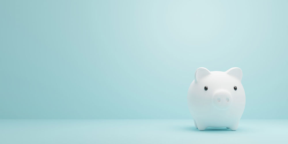 Close-up of piggy bank against blue background