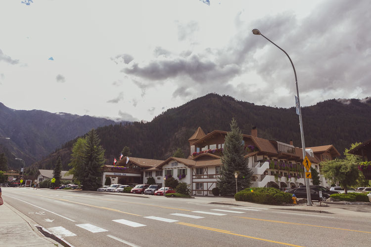 Street by buildings against sky in city