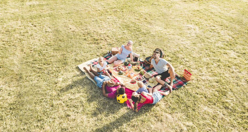 High angle view of family relaxing on field