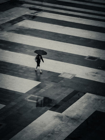 High angle view of a woman crossing on road