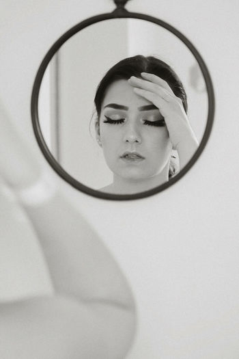 Portrait of woman with reflection in mirror