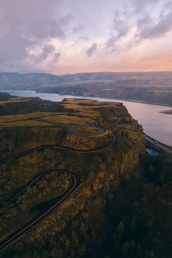 High angle view of cliff road against sky during sunrise